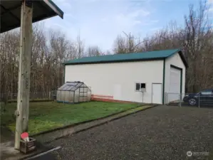 Side view of enclosed shop and greenhouse.