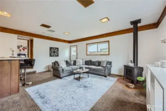 Garage converted into family room with a gas heat stove