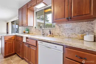 Updated kitchen with granite countertops sits between Dining and Family Rooms.