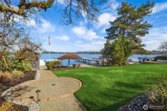 Level lawn with lake irrigation & landscape lighting.