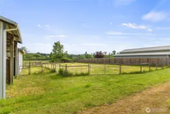 Smaller fenced paddock adjacent to the barn and a larger fenced outdoor area that was previously used as an outdoor riding arena but subsequently converted to additional pasture.