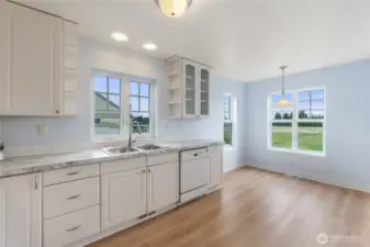 The kitchen and nook area of the home have a lovely pastoral view. You can see all the way to the end of the property.