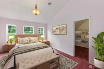 Virtually staged primary bedroom on main floor.  Primary bath is to the left.