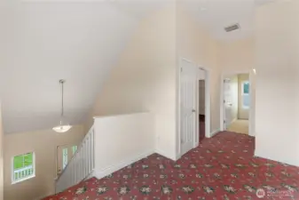 The upstairs landing looks down at the foyer. It's very open and has a lot of natural light coming in from the big windows. There is enough space to accommodate a small desk or reading nook.