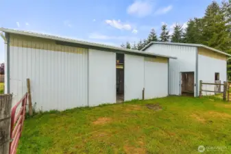 The two detached farm buildings on the eastside of the home include 5 stalls, a tack room, covered trailer/RV parking and/or shaving storage.