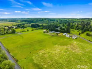The landscape stretches wide and open & is blanketed in lush, green fields.