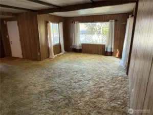 Spacious family room with three large picture windows.