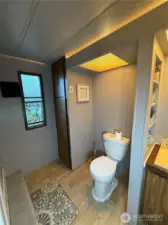 Linen and towel storage. Toilet across from shower.