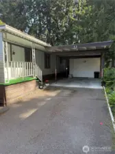 Full carport with storage shed.