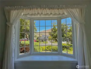 Charming bay window invites natural light and creates a cozy nook