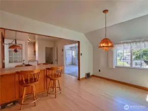 Dining room with breakfast bar seating gives extra storage space & separates from kitchen area.