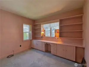 Bedroom 2 of 2 on main floor with built-in wall unit.
