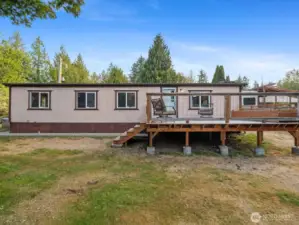 Rear of the building features a deck overlooking the private backyard.