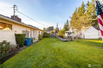 The backyard has some grassy area.