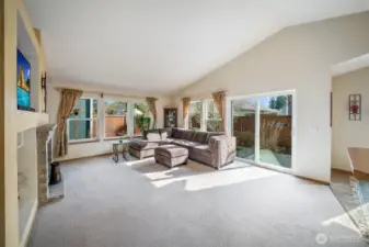 Vaulted ceilings and large banks of windows in the living room make the space feel bright and airy