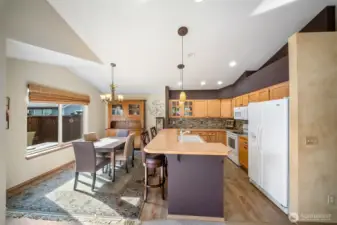 Spacious kitchen with breakfast bar is open to dining and living areas