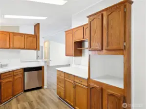 Kitchen featuring warm oak cabinetry with abundant storage and workspace for everyday cooking. Dedicated microwave space or the perfect space for your beverage center.