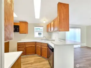 Another view of the kitchen highlighting the cabinetry and functional counter space and bar seating. The range will be installed soon.