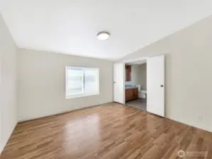 Spacious primary bedroom featuring double-door entry into the primary bath  that adds a sense of luxury and provides easy access.