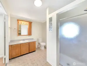Primary bath with a large single-sink vanity and open floor space that creates a comfortable, easy-to-use layout.