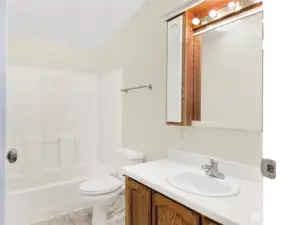 Bright hall bath with great lighting and a clean, functional layout.