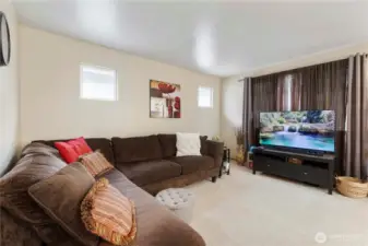 The generous, open concept living room is bright & cheery and offers a great space for enjoying a good movie or book