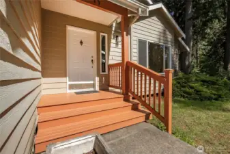 A spacious front porch offers a warm welcome to every guest who arrives.