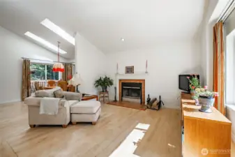 The open main living area features vaulted ceilings and skylights, bringing in great natural light and enhancing the sense of space.