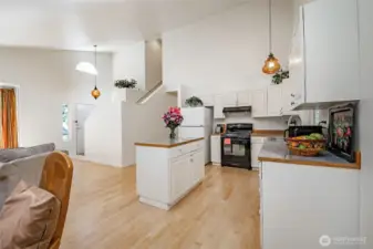 The open kitchen with island offers ample space for cooking and entertaining, allowing you to move comfortably while staying connected with guests.