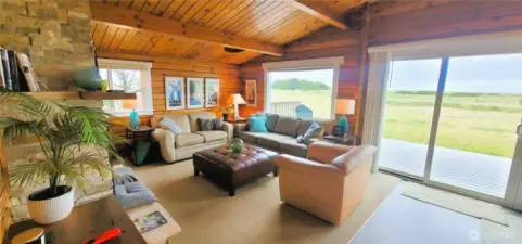 Rustic warmth meets oceanfront elegance in this stunning space, where Lindal Cedar walls frame breathtaking Pacific views, creating a cozy yet sophisticated coastal retreat."  "Rustic warmth meets oceanfront elegance in this stunning space, where rich log walls frame breathtaking Pacific views, creating a cozy yet sophisticated coastal retreat.