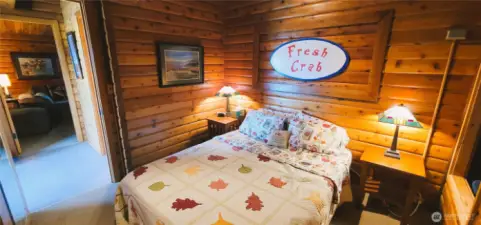 A cozy second bedroom on the main floor, featuring a charming reading nook that invites relaxation. Warm wood tones, soft lighting, and thoughtful design create the perfect retreat for unwinding with a good book.