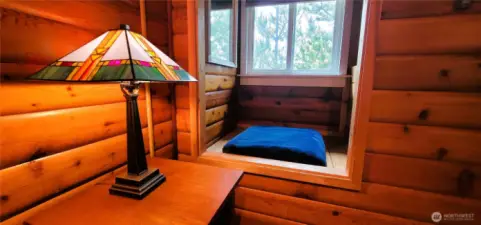 A thoughtfully designed space where the reading nook and closet seamlessly blend, creating a cozy and functional retreat.