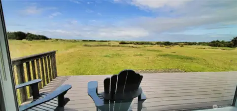 A breathtaking deck where coastal serenity meets panoramic views—overlooking the rolling dunes and the vast expanse of the Pacific Ocean. This inviting outdoor space offers the perfect vantage point for soaking in stunning sunsets and the soothing sounds of the waves.