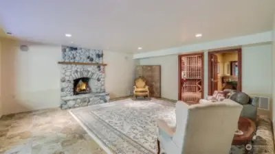 This expansive lower-level recreational area is the perfect space for relaxation and entertainment. Featuring a cozy stone fireplace as the focal point, the room exudes warmth and charm. Conveniently attached to this space are a half bath, laundry room, and a beautifully crafted wine cellar.