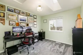 One of 4 upstairs bedrooms; note skylight too