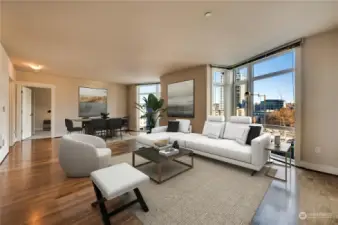 Spacious living & dining area with gorgeous, engineered wood flooring through-out main living area with floor to ceiling windows maximizing natural light into the home.  This is virtually staged.