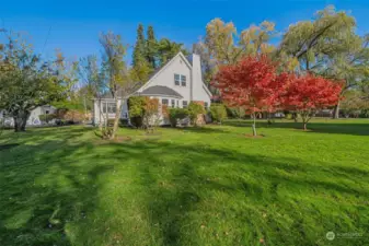 Lush beautiful gardens completely surround this charming tudor.