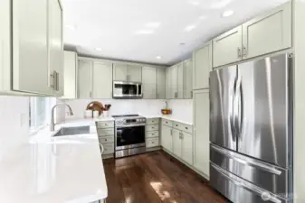 New cabinets, appliances, sink, cabinets - Chef's dream kitchen!  Gorgeous colors and attention to detail! Pull out garbage cans, tall pantry shelving next to fridge.  Thoughtful design decisions.