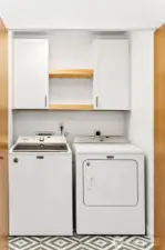 Upstairs laundry with new flooring and extra cabinets.