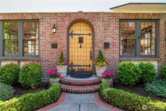Beautiful landscaping, original front door and windows greet you when approaching.