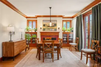 Room for many in the dining room with inviting fireplace and built-in cabinetry.