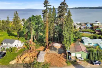Nice overview of lot seen with homesite cleared and ready to go.  Sellers rent the neighbors green shop to the right for $750/mo