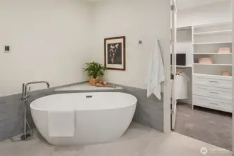 Indulge in the deep soaking tub located in the elegant primary bathroom