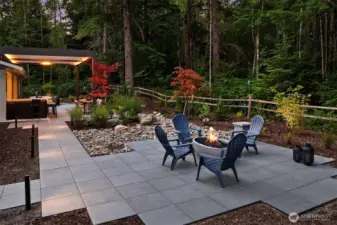 The landscape, green space, and walkways are beautifully illuminated with Lumiere outdoor lighting, offering timer functions and full color control for effortless ambiance