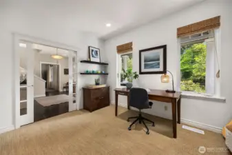 The front room off the foyer with glass framed pocket doors is a great home office and could also be a formal living room.