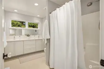 The shared full bath on the upper level with two sinks.