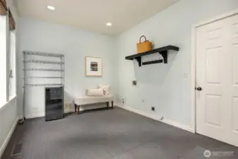 The mudroom off the kitchen has plenty of room and another washer/dryer hook up!