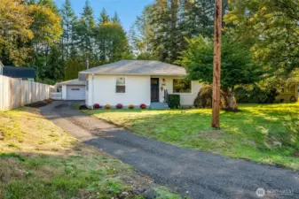 New crushed asphalt driveway with parking in the rear. The two car garage has work shop space and is 572 sq ft.