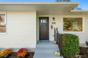 New railing and front door and colorful chrysanthemums welcome you to come on in!