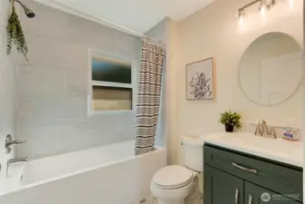 Deep soaking bathtub/shower, ceiling height tile, full storage cabinetry.